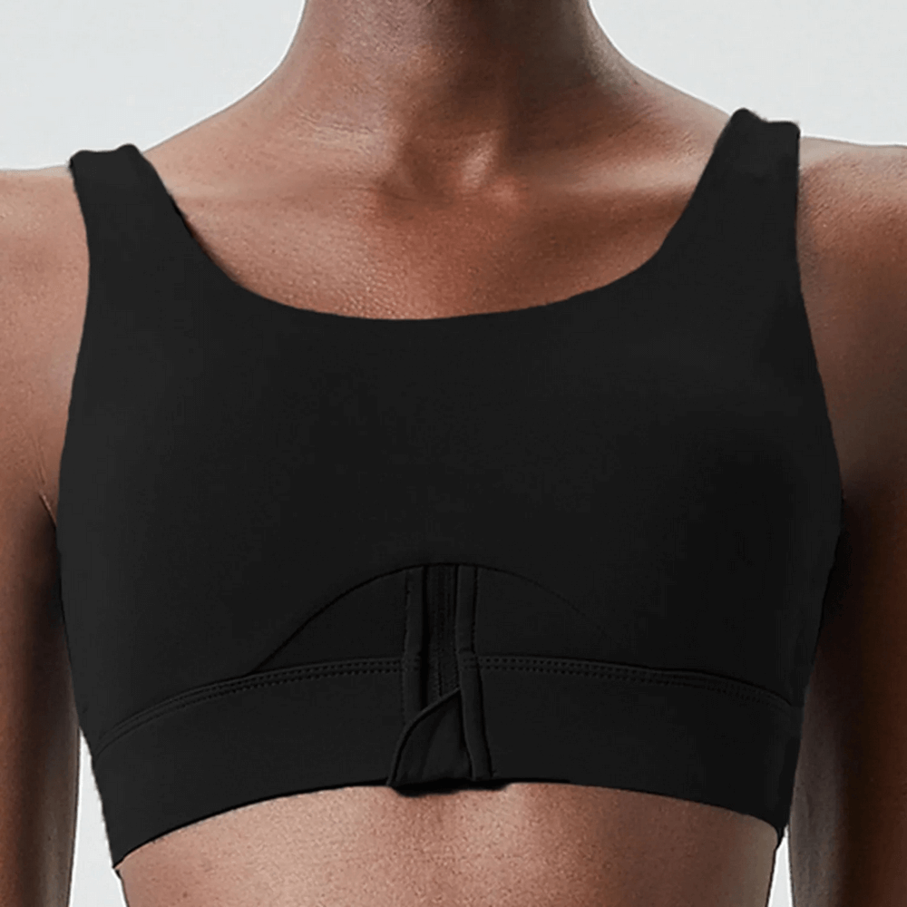 Women's high impact fitness yoga bra in solid black with a half-zip front, offering breathability and flexibility for intense workouts.